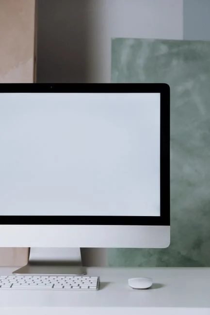 A modern computer screen displaying web design work, showcasing creative visuals in a workspace.